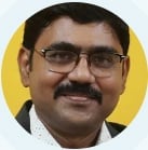 Headshot of a man wearing glasses with a mustache