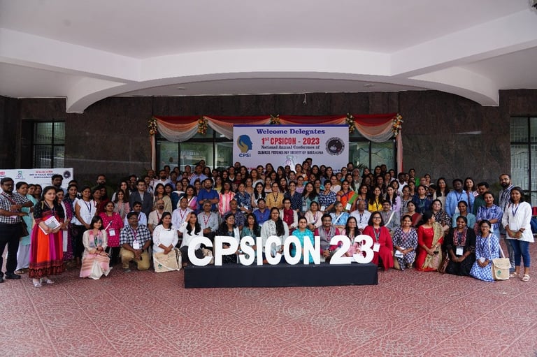 Large group of people posing for a photo in front of a CPSicon23 sign at an indoor conference venue