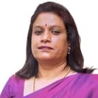 Woman with long dark hair wearing a purple top, portrait photo against white background